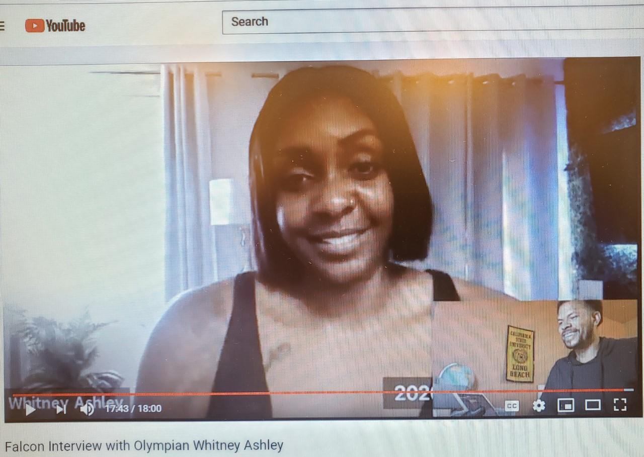 Whitney Ashley talks with Cerritos track head coach Christopher Richardson