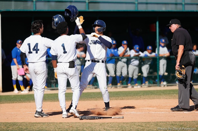 Mike Santos is greeted at home plate after his two-run home run