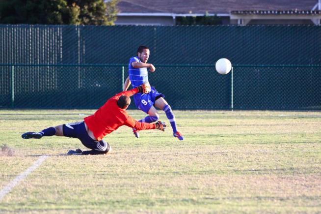 Nic Escalante (9) scores the second goal past Nolan Dean in the Falcons 2-0 win over El Camino.