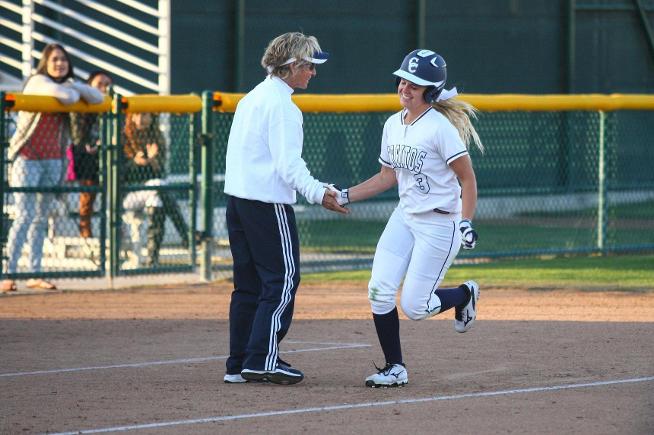 Mackenzie Kutzke is congratulated by head coach Kodee Murray after her go-ahead home run
