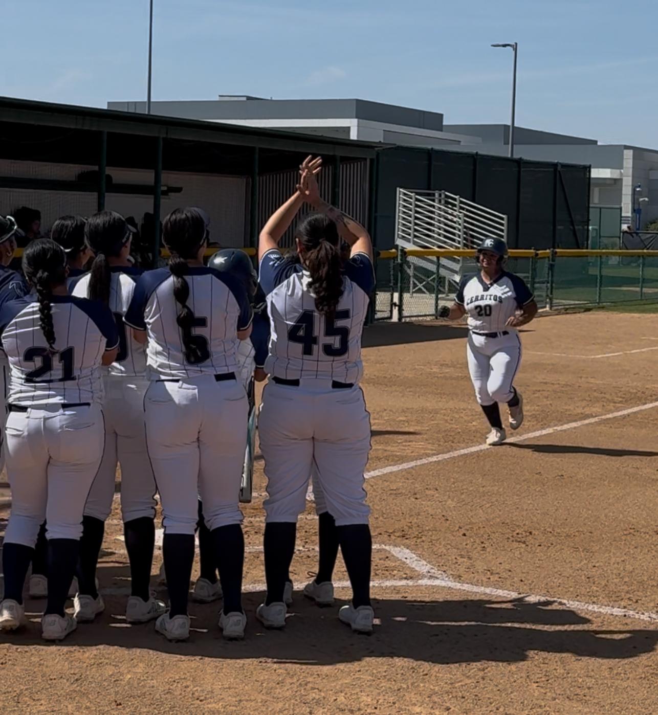 Falcons wait at home plate to celebrate with Marley Cortez after her home run