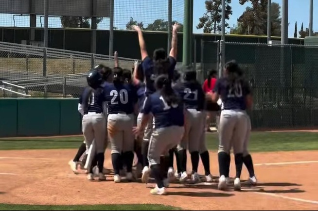 Falcons greet Tatyana Cortez at the plate after hitting a home run