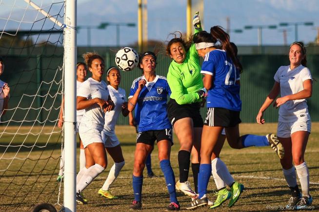 Amber Whitmore (21) heads home the game's lone goal in a 1-0 playoff win over Santiago Canyon